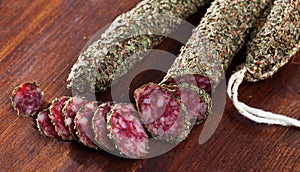 Fuet sausage coated with herbs