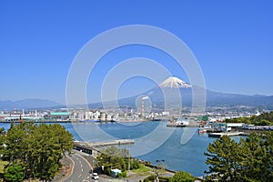 Fuji Mountain and Fisherman boats with Japan industry factory area background view from Tagonoura Fisheries Cooperative cafeteria