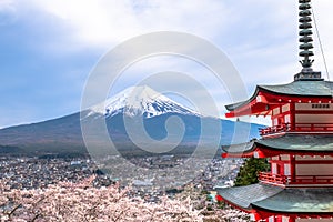 Fujiyoshida landmark of Japan Chureito red Pagoda on Fuji mountain background, clear sky almost in sunset light red Pagoda with pi