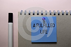 A Fulfilled Life text on sticky notes isolated on office desk photo