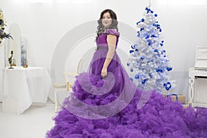 Full Asian woman in a lush lilac dress.