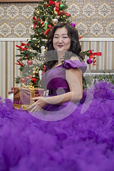 Full Asian woman in a lush lilac dress.