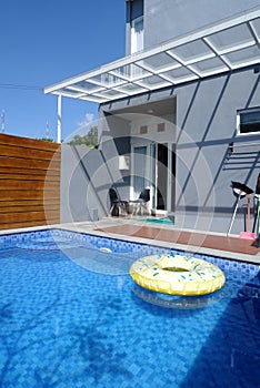 Full back porch view with yellow floaties on still water