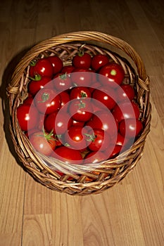 Full basket of ripe appetizing red tomatoes