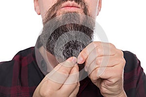 Full bearded man using beard balm or oil, care product for men