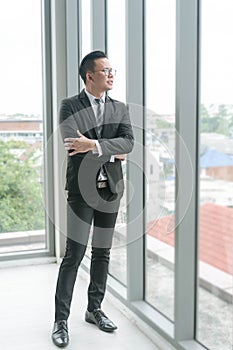 Full body of asian businessman in black suit at the office