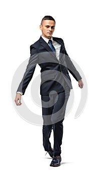 Full body of businessman walking with uncertain gait, isolated on a white background.