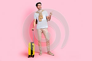 Full body cadre of young businessman enjoy travel cheap tickets lowcost airport direct finger mockup isolated on pink