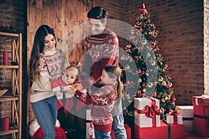 Full body of cheerful joyful family son daughter parenthood hold infant baby christmas tree indoors inside house home