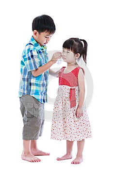 Full body. Elder brother is comforting his crying sister. Isolated on white background. Conceptual about familial love. photo