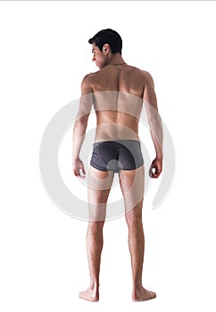 Full body of fit young man seen from the back in underwear isolated