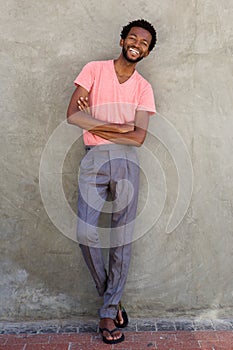 Full body handsome african american man smiling with arms crossed