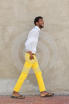 Full body handsome african man walking and smiling