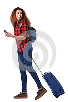 Full body happy travel woman walking with suitcase and mobile phone