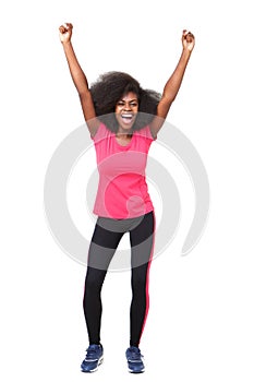 Full body happy young african american sports woman cheering with arms raised up