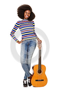 Full body happy young black woman standing with acoustic guitar against white background