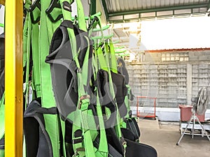 Full body harness hanging on the rack,personal protective equipment for  height work