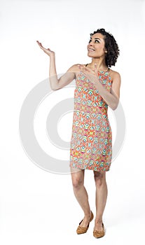 Full body image of a young woman. She is looking and pointing up