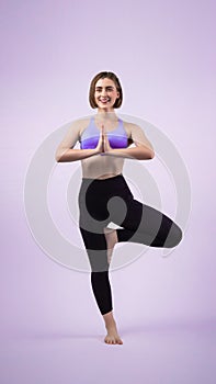 Full body length gaiety shot athletic and sporty woman doing yoga