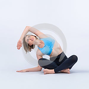 Full body length gaiety shot athletic and sporty woman doing yoga