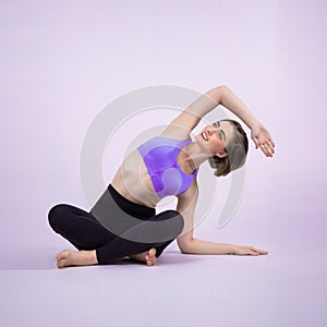 Full body length gaiety shot athletic and sporty woman doing yoga