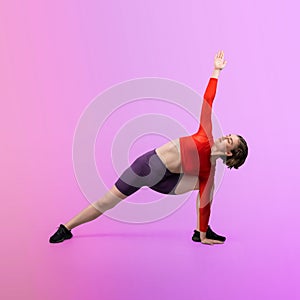 Full body length gaiety shot athletic and sporty woman doing yoga