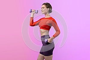 Full body length gaiety shot athletic and sporty woman with dumbbell