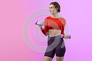 Full body length gaiety shot athletic and sporty woman with dumbbell