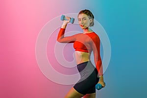 Full body length gaiety shot athletic and sporty woman with dumbbell