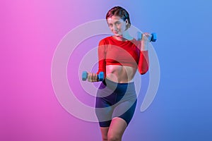 Full body length gaiety shot athletic and sporty woman with dumbbell