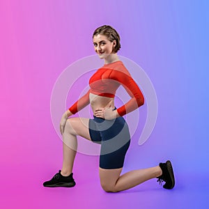 Full body length gaiety shot athletic sporty woman in fitness exercise posture