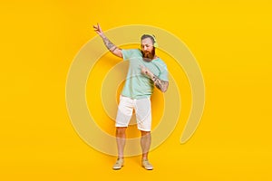 Full body length photo cadre of crazy irish man youngster wear stylish summertime outfit listen headphones dance
