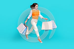 Full body length photo of excited businesswoman hold packages from zara new collection discount promotion isolated on