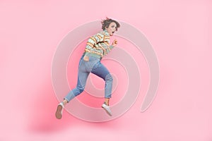 Full body length photo of funky running away trampoline young woman nervous confused scared anxious isolated on pink