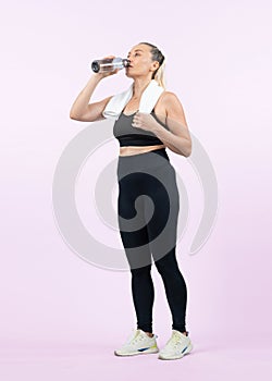 Full body length shot athletic and sporty senior woman drinking water. Clout
