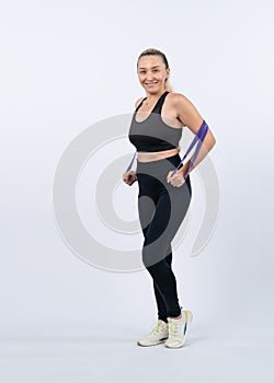 Full body length shot athletic sporty senior woman with resistance band. Clout