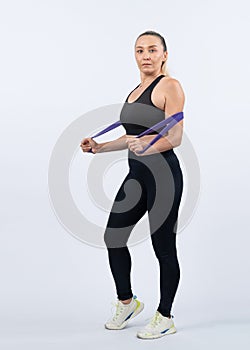 Full body length shot athletic sporty senior woman with resistance band. Clout