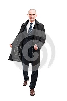 Full body of middle age business man posing wearing raincoat