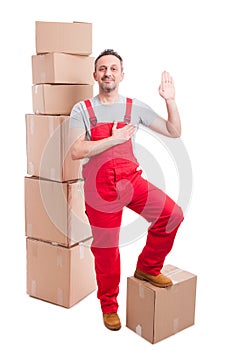 Full body of mover man in overall making swear gesture
