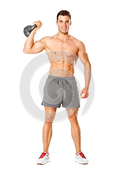 Full body of muscular man exercising with dumbbell on white