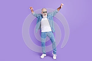 Full body photo of aged man happy positive smile have fun dance party isolated over violet color background