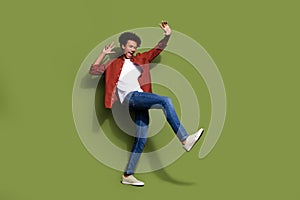 Full body photo of attractive young man happy energetic dancing wear trendy brown clothes isolated on khaki color