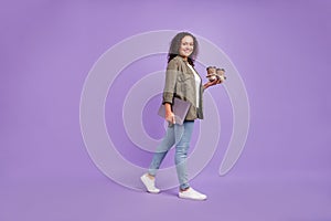 Full body photo of brunette hair trendy afro american woman walk hold coffee laptop isolated on purple color background