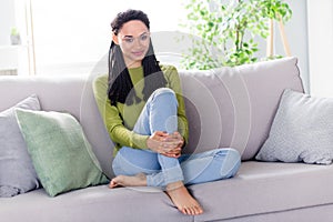 Full body photo of calm peaceful woman sit sofa good mood smile indoors inside house home