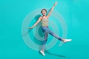 Full body photo of carefree cheerful lady good mood rejoice enjoy dancing isolated on teal color background