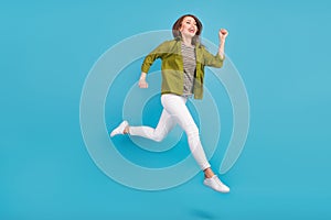 Full body photo of charming happy nice woman jump up run empty space isolated on blue color background