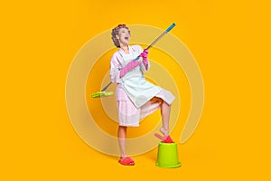 Full body photo crazy girl wash floor mop famous guitar player wear bath robe isolated yellow color background