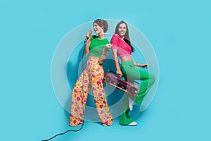 Full body photo of crazy girls jazz singers vocal music creators hold microphone hold cassette player isolated on blue