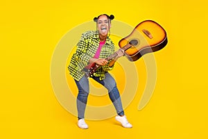 Full body photo of crazy happy afro american woman play guitar funky mood isolated on yellow color background