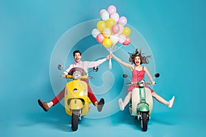 Full body photo of crazy two people lady guy drive retro moped travelers spread legs raise arms many air balloons